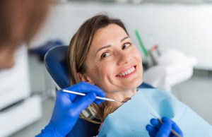 Patient smiling during CEREC crown fitting — same-day restoration with precise fit