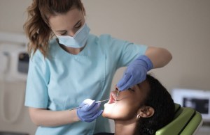 Hygienist performing root canal therapy — gentle care for infected tooth preservation