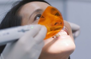 Dentist placing temporary restoration on a female patient