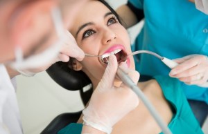Hygienist cleaning patient’s teeth — preventive care for lifelong oral wellness
