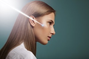 Woman receiving Opus Plasma laser treatment near ear