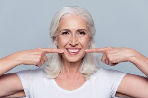 Senior woman smiling broadly — confident, secure smile with All-on-6 implant dentures