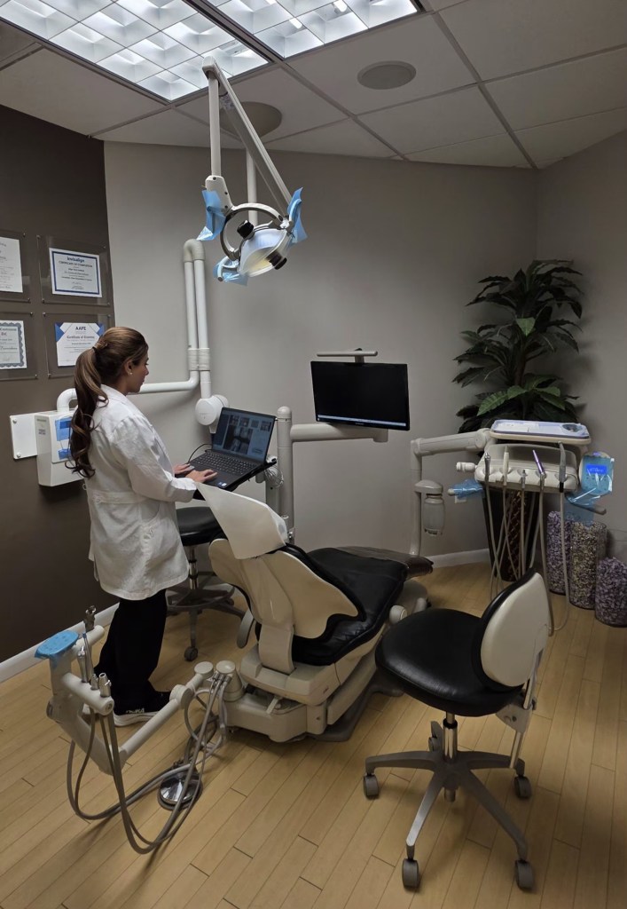 Reston Dentist standing working in exam room