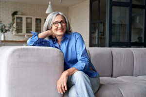 woman sitting on couch smiling